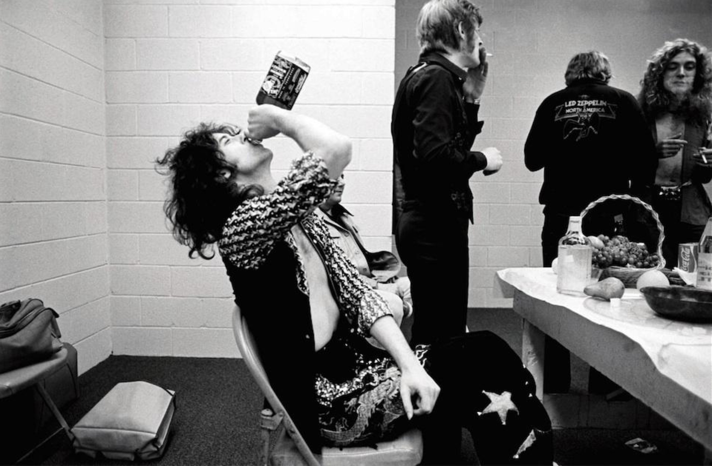 Led Zeppelin's Jimmy Page guzzling a bottle of Jack Daniels before going on stage in Indianapolis, 1975 